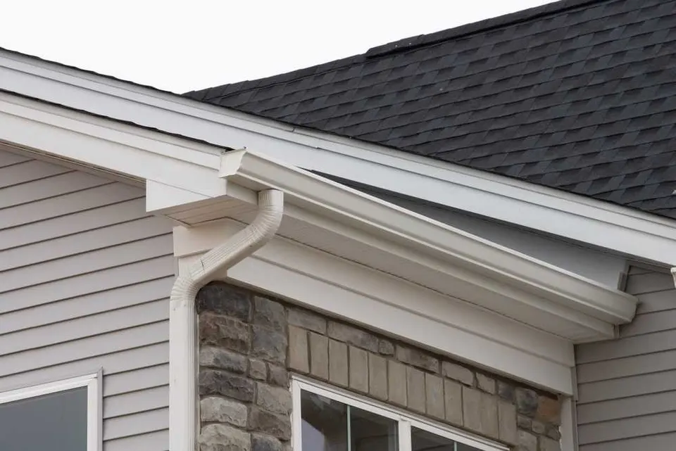 Labeled diagram of gutter system parts: gutter run, end cap, miter, downspout, elbow