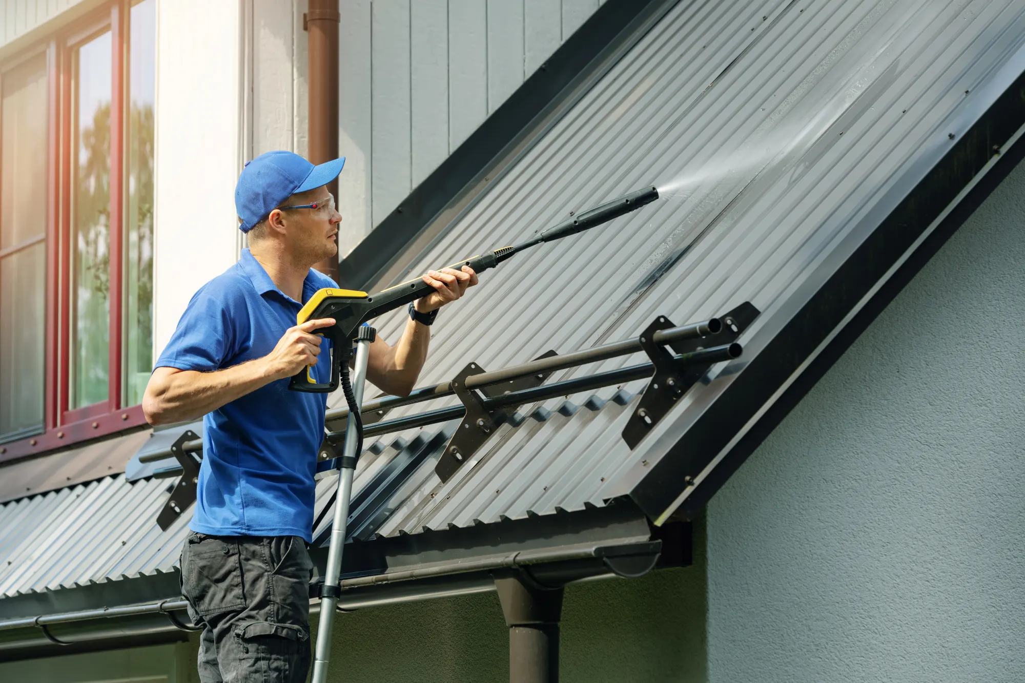 Low-pressure roof cleaning in progress